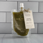 Vesl Studio olive fields squeeze wax melt with a label on a tiled background